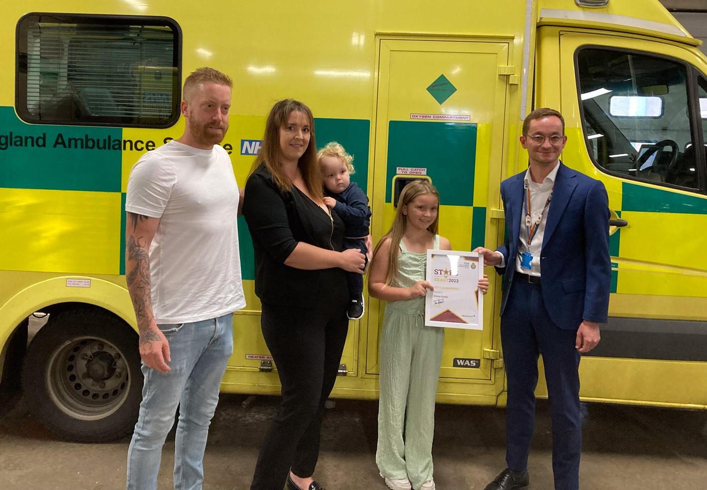 pciture of a family with EEAST staff with an award