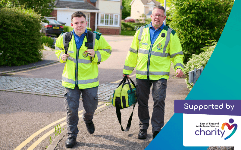 Two community first responders walking down a path holding bags. Text reads: supported by the EEAST Charity.