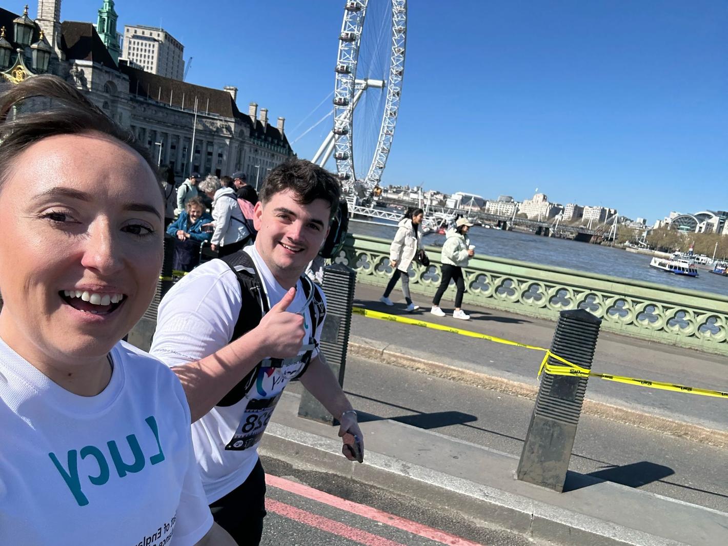 Two charity runners running past the London Eye on the London Landmarks Half Marathon